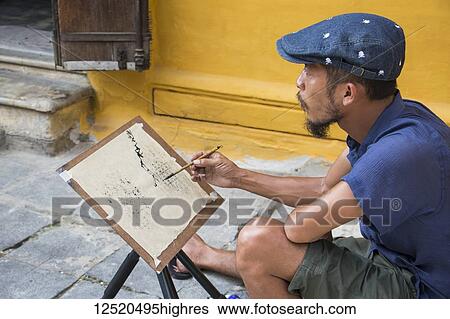 Man painting on the street in the Old Quarter; Hoi An, Quang Nam, Vietnam View Large Photo Image Stock Photograph - Man painting on the street in the Old Quarter; Hoi An, Quang Nam, Vietnam. Fotosearch