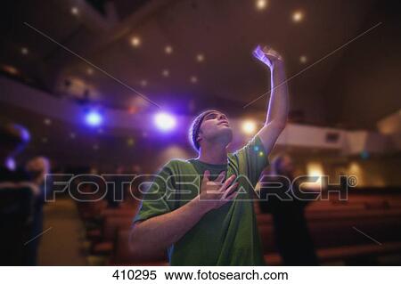 Stock Photography - Man raising hand in worship. Fotosearch