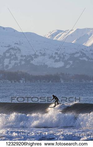 Man riding a wave, Kachemak Bay, South-central Alaska; Homer, Alaska, United States of America View Large Photo Image Stock Photograph - Man riding a wave, Kachemak Bay, South-central Alaska; Homer, Alaska, United States of America. Fotosearch