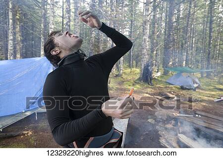 Man snacking in camp, Southeast Alaska; Alaska, United States of America View Large Photo Image Stock Photograph - Man snacking in camp, Southeast Alaska; Alaska, United States of America. Fotosearch