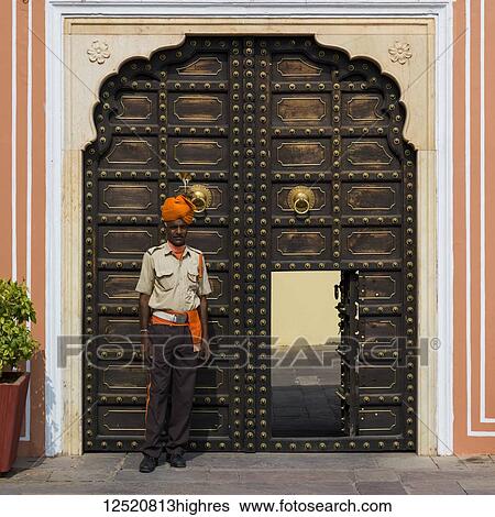 Man standing outside an ornate doorway to the City Palace; Jaipur, Rajasthan, India View Large Photo Image Stock Photograph - Man standing outside an ornate doorway to the City Palace; Jaipur, Rajasthan, India. Fotosearch