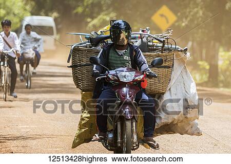 Man transporting vegetables on a motorcycle; Sambor Prei Kuk, Kompong Thom, Cambodia View Large Photo Image Stock Photograph - Man transporting vegetables on a motorcycle; Sambor Prei Kuk, Kompong Thom, Cambodia. Fotosearch