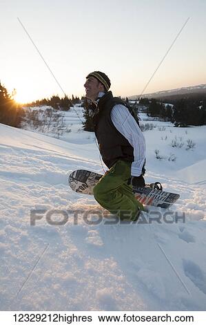Man walking uphill with a snowboard at sunset, near Homer, South-central Alaska; Alaska, United States of America View Large Photo Image Stock Photograph - Man walking uphill with a snowboard at sunset, near Homer, South-central Alaska; Alaska, United States of America. Fotosearch
