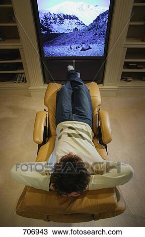 Man watches television View Large Photo Image Stock Image - Man watches television. Fotosearch