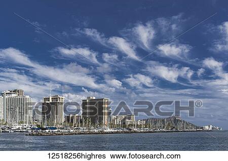 Stock Photograph - Mare's tails (cirrus uncinus clouds) over Waikiki; Honolulu, Oahu, Hawaii, United States of America. Fotosearch