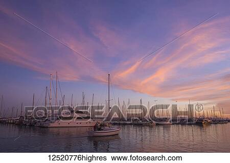 Stock Photograph - Marina with sailboats and yachts at sunset; Santa Barbara, California, United States of America. Fotosearch