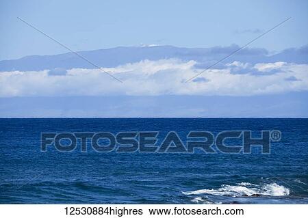 Stock Photograph - Mauna Kea with snow and observatories viewed from North Kohala coast; Island of Hawaii, Hawaii, United States of America. Fotosearch