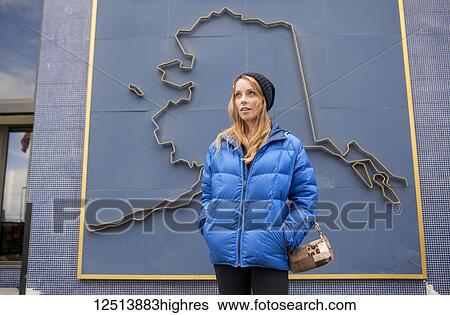 Mid adult woman standing in front of a 3D graphic of the outline of Alaska on a building in downtown Anchorage, South-central Alaska; Anchorage, Alaska, United States of America View Large Photo Image Stock Photograph - Mid adult woman standing in front of a 3D graphic of the outline of Alaska on a building in downtown Anchorage, South-central Alaska; Anchorage, Alaska, United States of America. Fotosearch