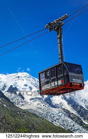 Stock Photograph - Mont Blanc and Aiguille du Midi Cable Car under blue sky, viewed from Plan de l'Aiguille; Chamonix-Mont-Blanc, Haute-Savoie, France. Fotosearch