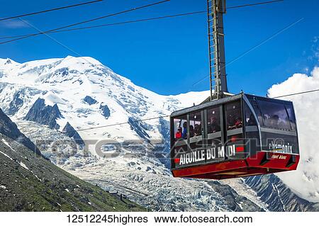 Stock Photograph - Mont Blanc and Aiguille du Midi Cable Car under blue sky, viewed from Plan de l'Aiguille; Chamonix-Mont-Blanc, Haute-Savoie, France. Fotosearch