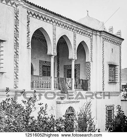 Stock Photograph - Moorish villa with windows protected by iron bars, Magic lantern slide, circa 1900; Algiers, Algeria. Fotosearch