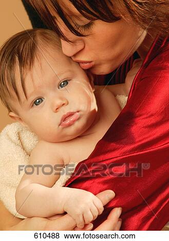 Stock Photo - Mother kisses baby. Fotosearch