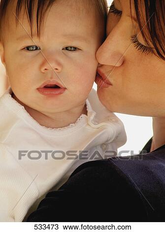 Stock Image - Mother kissing baby. Fotosearch