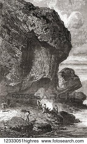 Stock Photograph - Neanderthal man under the rock shelter of the Bruniquel Cave, France in prehistoric times. From L'Homme Primitif, published 1870.. Fotosearch