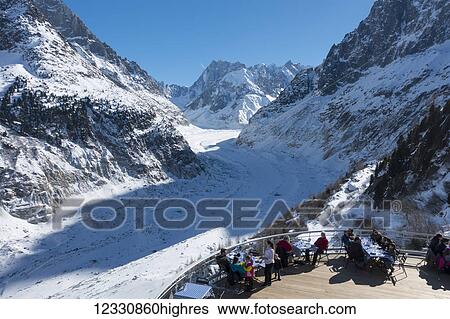 Stock Photograph - Observation Balcony With Restaurant Patio Overlooking Mer De Glace Glacier And Mont Blanc Massif; Montenvers, France. Fotosearch