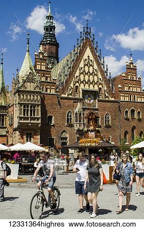 Stock Photograph - Old Town Hall, Astronomical Clock And People Strolling On Market Square; Wroclaw, Poland. Fotosearch