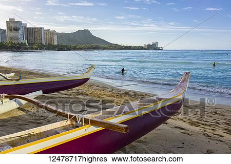 Stock Photograph - Outrigger canoes, Waikiki and Diamond Head on the island of Oahu; Honolulu, Oahu, Hawaii, United States of America. Fotosearch