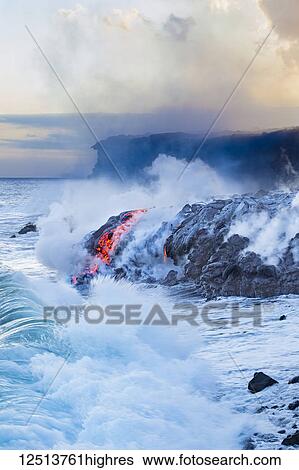 Stock Photograph - Pahoehoe lava flowing from Kilauea has reached the Pacific ocean near Kalapana; Island of Hawaii, Hawaii, United States of America. Fotosearch