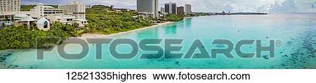 Stock Photograph - Panorama of hotels and beach on Tumon Bay; Tamuning, Mariana Islands; Guam, Micronesia. Fotosearch