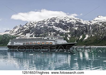 Stock Photograph - Passengers line the rails on the bow of the Holland America cruise ship Volendam in upper Tarr Inlet in front of Margerie Glacier, Glacier Bay National Park and Preserve, Southeast Alaska; Alaska, United States of America. Fotosearch