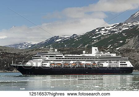 Stock Photograph - Passengers line the rails on the bow of the Holland America cruise ship Volendam in Tarr Inlet in front of Grand Pacific Glacier, Glacier Bay National Park and Preserve, Southeast Alaska; Alaska, United States of America. Fotosearch