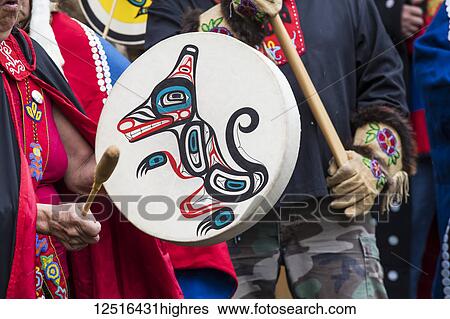 Stock Photograph - People at the Tlingit Celebration, participants are entering the hall to traditional drumming; Teslin, Yukon, Canada. Fotosearch