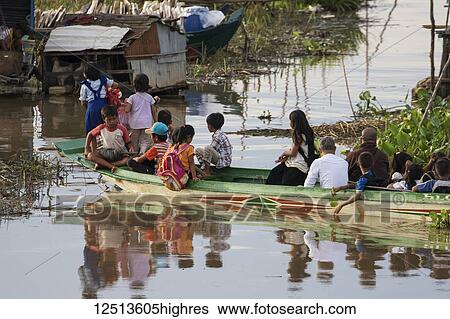 People in a public boat by a floating village in the Tonle Sap; Siem Reap, Cambodia View Large Photo Image Stock Photograph - People in a public boat by a floating village in the Tonle Sap; Siem Reap, Cambodia. Fotosearch
