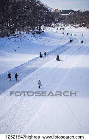 People walking and skating along the Red River Mutual Trail; Winnipeg, Manitoba, Canada View Large Photo Image Stock Photograph - People walking and skating along the Red River Mutual Trail; Winnipeg, Manitoba, Canada. Fotosearch