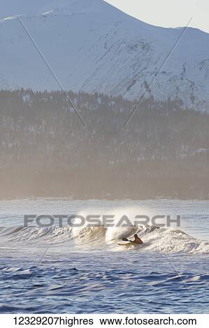 Stock Photograph - Person kayak surfing a wave, Kachemak Bay, Homer, South-central Alaska, USA. Fotosearch