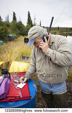 Person On A Satellite Phone During A Remote Moose Hunt, Lake Iliamna, Southwest Alaska, USA View Large Photo Image Stock Photograph - Person On A Satellite Phone During A Remote Moose Hunt, Lake Iliamna, Southwest Alaska, USA. Fotosearch