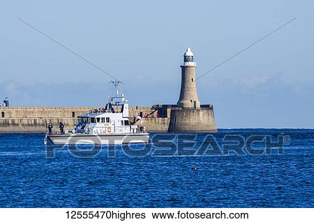 Stock Photograph - Pier with lighthouse and boat on the River Tyne; South Shields, Tyne and Wear, England. Fotosearch