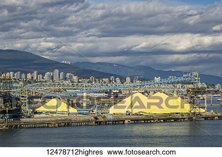 Stock Photograph - Piles of sulphur in the port for shipping from Vancouver; Vancouver, British Columbia, Canada. Fotosearch