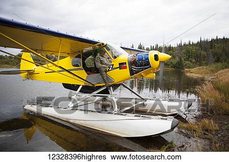 Stock Photograph - Pilot In A Piper J-3 Super Cub Beach On Lake Iliamna, Southwest Alaska, USA. Fotosearch
