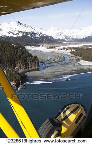 Stock Photograph - Piper Super Cub in flight over the Kenai Peninsula Outer Coast, Point of view, South-central Alaska; Alaska, United States of America. Fotosearch