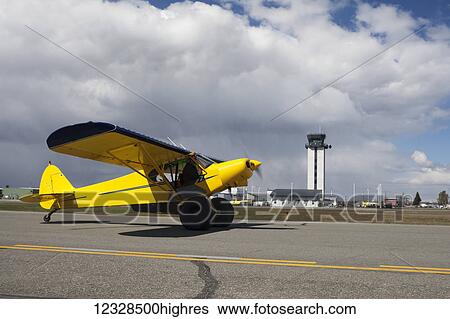 Stock Photograph - Piper Super Cub on the runway at Merrill Field, South-central Alaska; Anchorage, Alaska, United States of America. Fotosearch