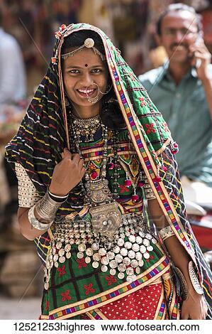 Portrait of a Hindu Indian woman in colourful traditional clothing and accessories, Jaisalmer Fort; Jaisalmer, Rajasthan, India View Large Photo Image Stock Photograph - Portrait of a Hindu Indian woman in colourful traditional clothing and accessories, Jaisalmer Fort; Jaisalmer, Rajasthan, India. Fotosearch