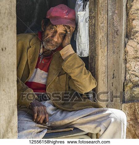 Stock Photograph - Portrait of a senior Cuban man with a cigar; Havana, Cuba. Fotosearch