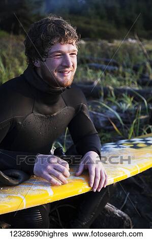 Portrait of a surfer with his surfboard near Yakutat, Southeast Alaska; Alaska, United States of America View Large Photo Image Stock Photograph - Portrait of a surfer with his surfboard near Yakutat, Southeast Alaska; Alaska, United States of America. Fotosearch