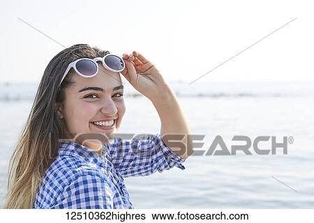 Portrait of a teenage girl at the water's edge at Woodbine Beach in summer; Toronto, Ontario, Canada View Large Photo Image Stock Photograph - Portrait of a teenage girl at the water's edge at Woodbine Beach in summer; Toronto, Ontario, Canada. Fotosearch