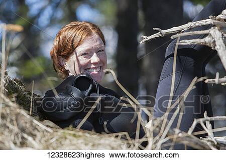 Portrait of a woman in a wetsuit sunning near the Gulf of Alaska, South-central Alaska; Alaska, United States of America View Large Photo Image Stock Photograph - Portrait of a woman in a wetsuit sunning near the Gulf of Alaska, South-central Alaska; Alaska, United States of America. Fotosearch