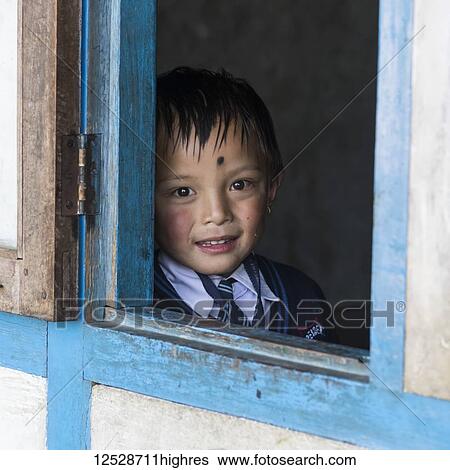 Portrait of a young boy in a school uniform looking out the window; Sikkim, India View Large Photo Image Stock Photograph - Portrait of a young boy in a school uniform looking out the window; Sikkim, India. Fotosearch