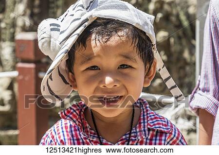 Portrait of a young Cambodian boy with a cute cap in the likeness of a zebra; Angkor Thom, Siem Reap, Cambodia View Large Photo Image Stock Photograph - Portrait of a young Cambodian boy with a cute cap in the likeness of a zebra; Angkor Thom, Siem Reap, Cambodia. Fotosearch
