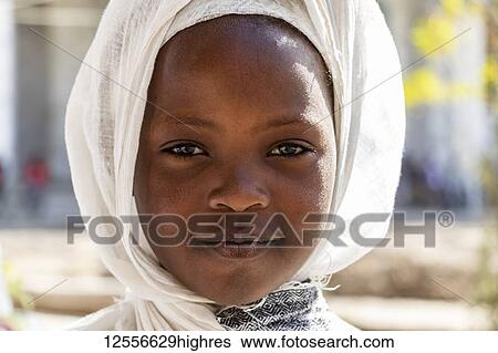Stock Photograph - Portrait of a young Ethiopian girl at the Church of Saint George during Timkat, the Orthodox Tewahedo celebration of Epiphany, celebrated on January 19th; Ziway, Oromia Region, Ethiopia. Fotosearch