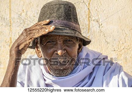 Stock Photograph - Portrait of an Eritrean man wearing a hat and looking into the camera, Monday livestock market; Keren, Anseba Region, Eritrea. Fotosearch
