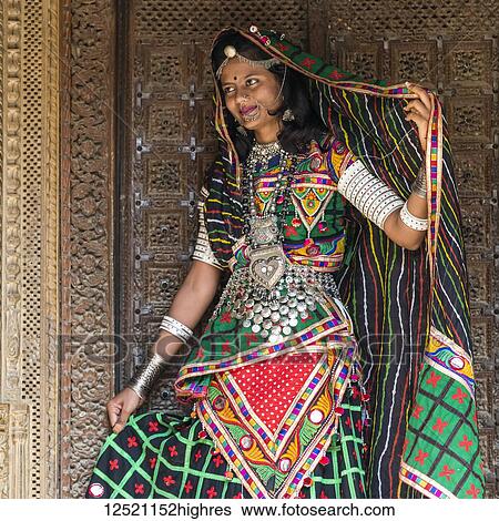 Stock Photograph - Portrait of an Indian woman in colourful traditional clothing and accessories; Jaisalmer, Rajasthan, India. Fotosearch