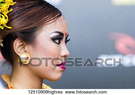 Portrait of the profile of a Thai young woman's face with cosmetics and a hairstyle with flowers; Bali, Indonesia View Large Photo Image Stock Photograph - Portrait of the profile of a Thai young woman's face with cosmetics and a hairstyle with flowers; Bali, Indonesia. Fotosearch