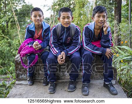 Portrait of three male students in uniform sitting on a concrete ledge, Glenburn Tea Estate; Darjeeling, West Bengal, India View Large Photo Image Stock Photograph - Portrait of three male students in uniform sitting on a concrete ledge, Glenburn Tea Estate; Darjeeling, West Bengal, India. Fotosearch