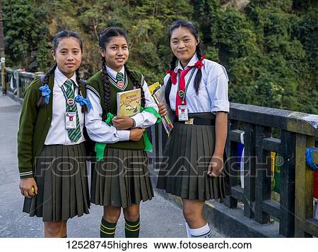 Stock Photograph - Portrait of three young women in school uniforms; Tista Bazar, Sikkim, India. Fotosearch