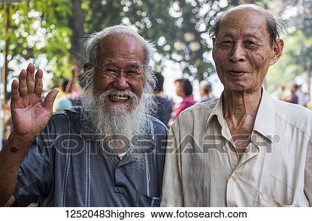 Pose of senior men smiling and waving for the camera; Hanoi, Hanoi, Vietnam View Large Photo Image Stock Photograph - Pose of senior men smiling and waving for the camera; Hanoi, Hanoi, Vietnam. Fotosearch