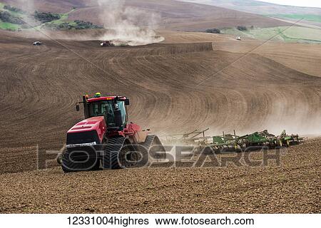 Stock Photograph - Quadtrac Tractor Cultivating A Garbanzo Bean Seedbed In The Palouse Region Of Eastern Washington; Washington, United States Of America. Fotosearch